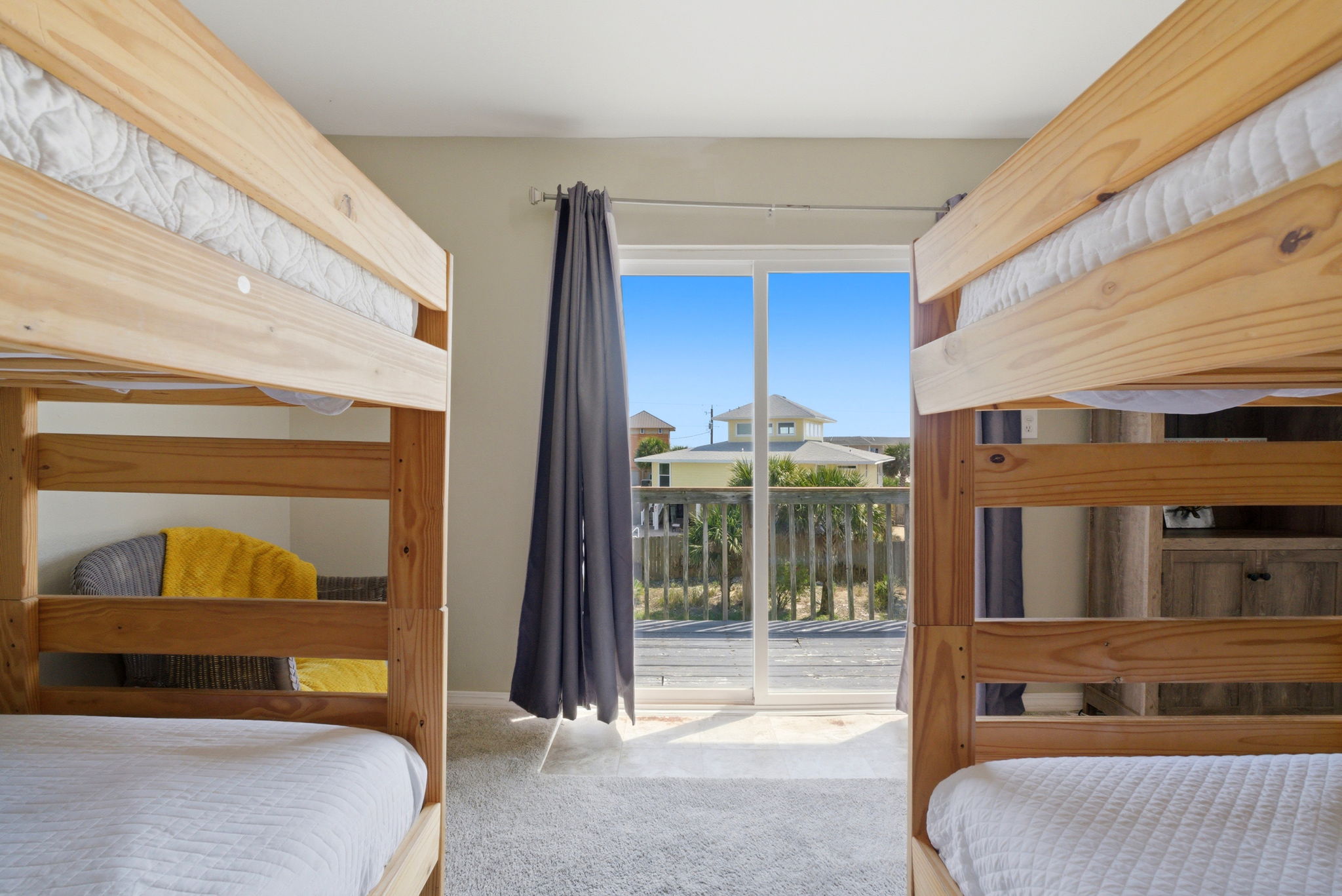 Bunk room with four bunks and upper balcony at Beach Blessings